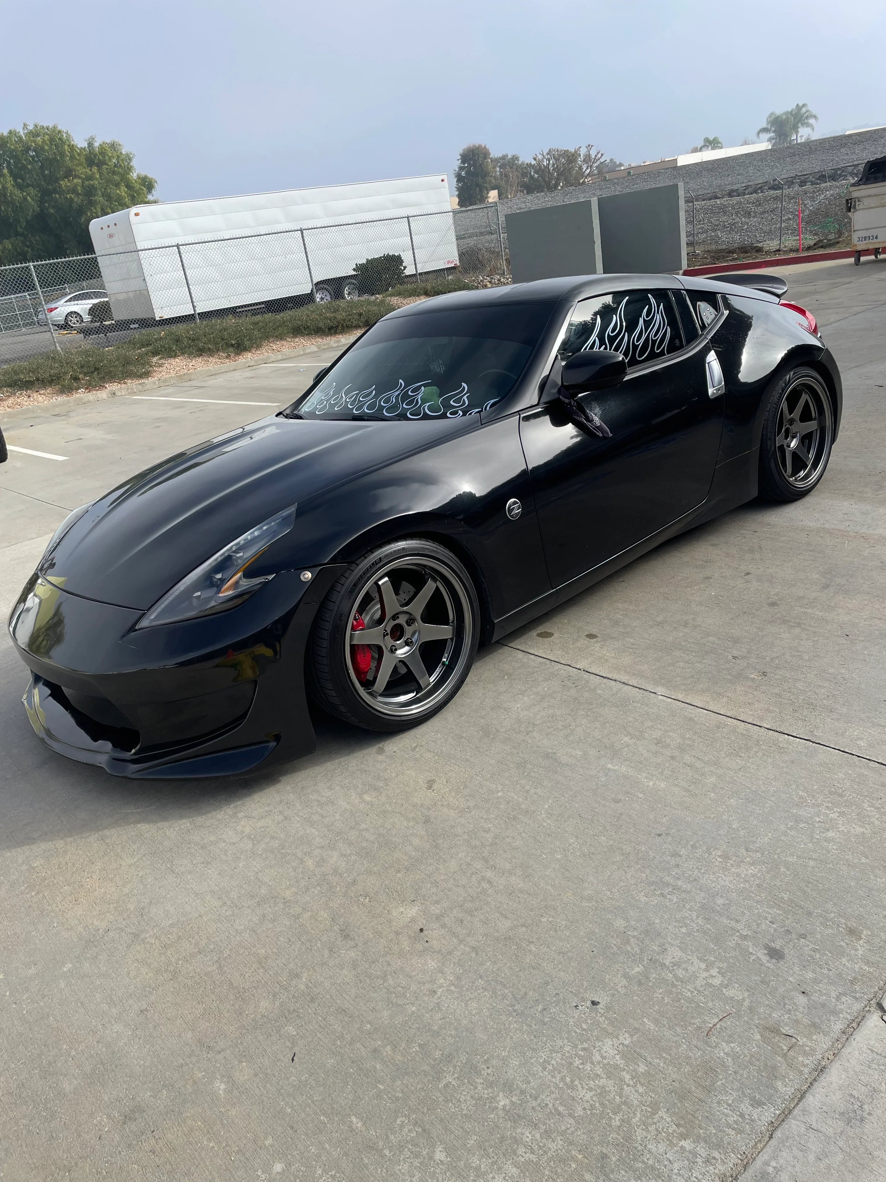 Black sports car with custom flame-design window tint on front and rear windows