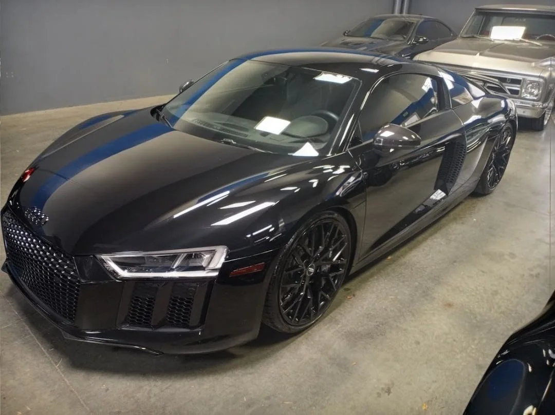 Black Audi R8 with professional window tint in indoor garage setting
